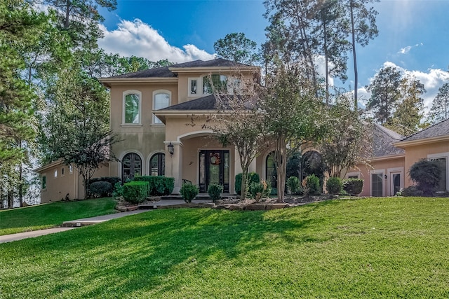 mediterranean / spanish-style house featuring a front lawn