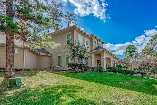 rear view of property featuring a yard