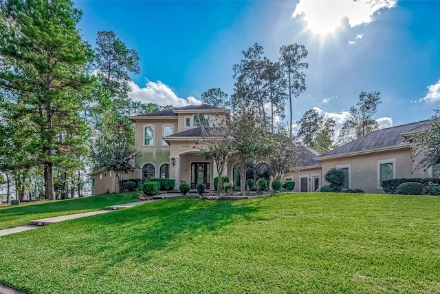 mediterranean / spanish home featuring a front yard