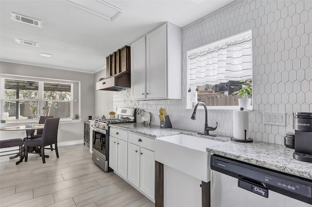 kitchen featuring white cabinetry, light stone counters, and appliances with stainless steel finishes