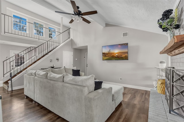 living room featuring dark hardwood / wood-style flooring, a textured ceiling, high vaulted ceiling, and ceiling fan