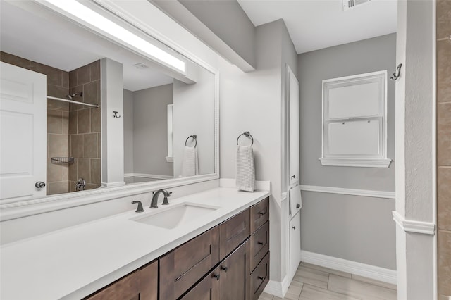 bathroom featuring vanity and a tile shower