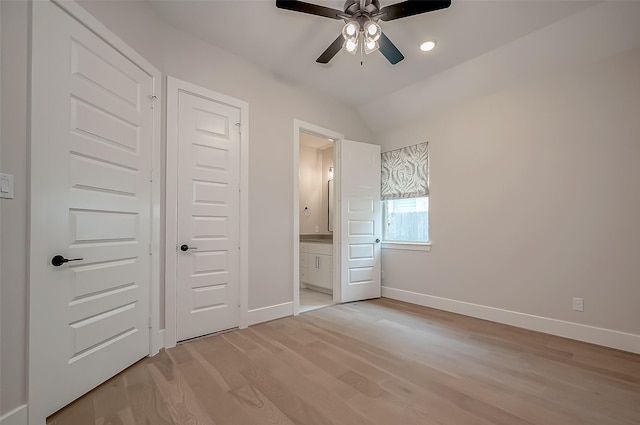 unfurnished bedroom with light wood-type flooring, ensuite bathroom, ceiling fan, and lofted ceiling