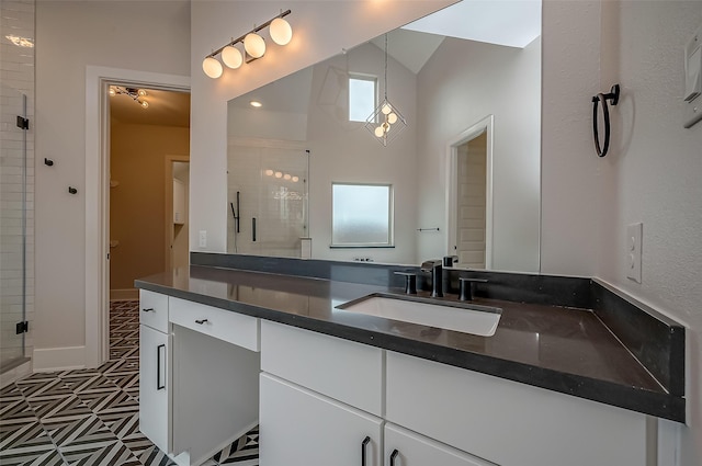 bathroom with vanity, a shower with shower door, and lofted ceiling