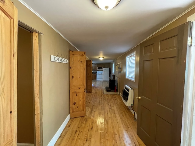 hallway featuring light hardwood / wood-style floors, crown molding, and heating unit