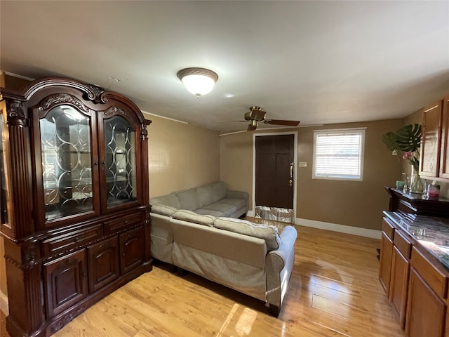 living room with ceiling fan and light hardwood / wood-style floors