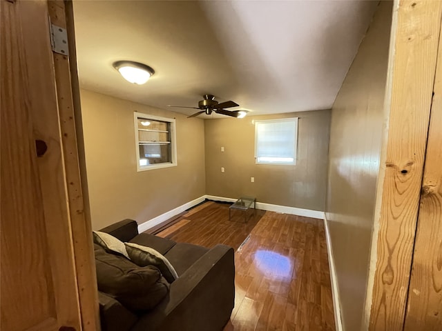 living area featuring hardwood / wood-style floors and ceiling fan