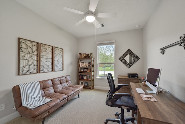 home office featuring light carpet and ceiling fan