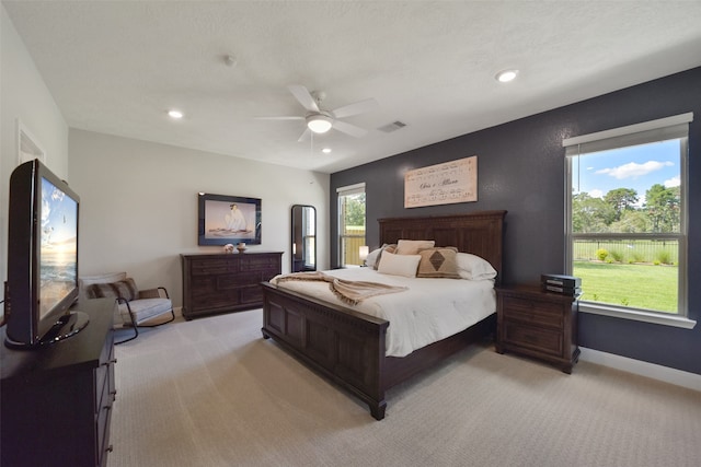 bedroom featuring ceiling fan and light carpet