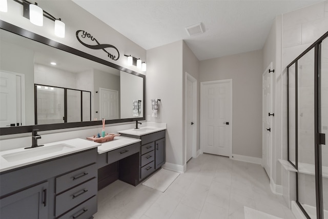 bathroom featuring vanity and a shower with door