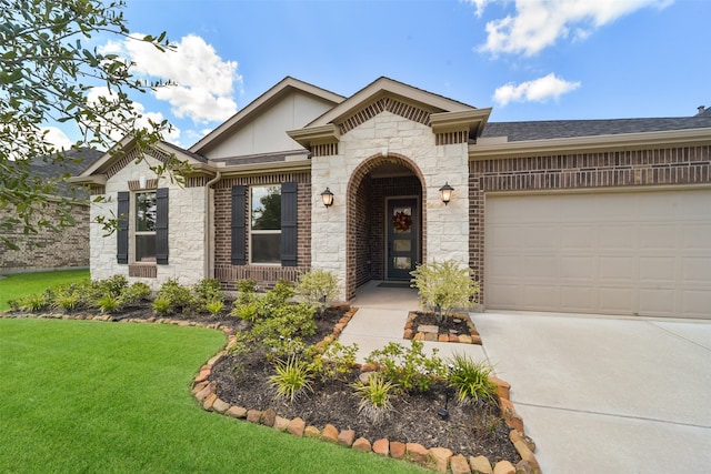 view of front of property with a garage and a front lawn