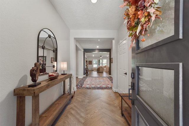 entryway with parquet floors and a textured ceiling