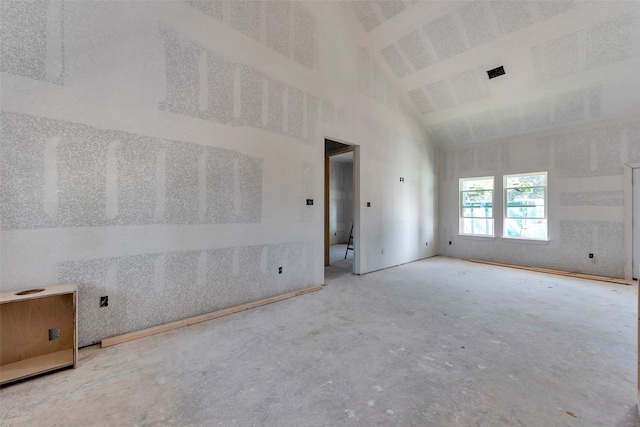 empty room featuring high vaulted ceiling