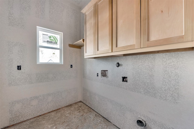 clothes washing area featuring cabinets