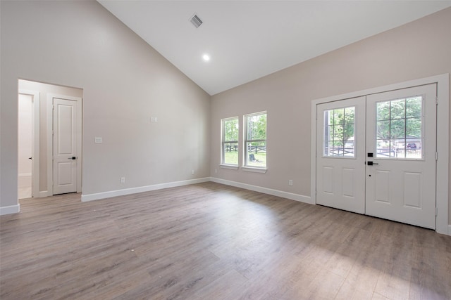 24601 Tipperary St, Hempstead, TX 77445 - entryway with high vaulted ceiling, visible vents, baseboards, and light wood finished floors