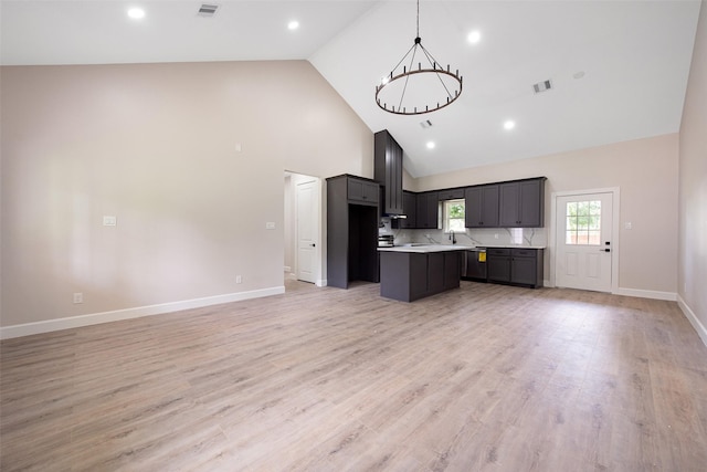 24601 Tipperary St, Hempstead, TX 77445 - kitchen featuring open floor plan, high vaulted ceiling, a center island, light countertops, and a chandelier