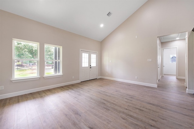 24601 Tipperary St, Hempstead, TX 77445 - unfurnished living room with visible vents, attic access, wood finished floors, and high vaulted ceiling