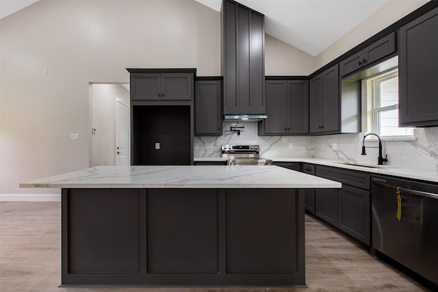 24601 Tipperary St, Hempstead, TX 77445 - kitchen featuring backsplash, a sink, light stone counters, light wood finished floors, and stainless steel appliances