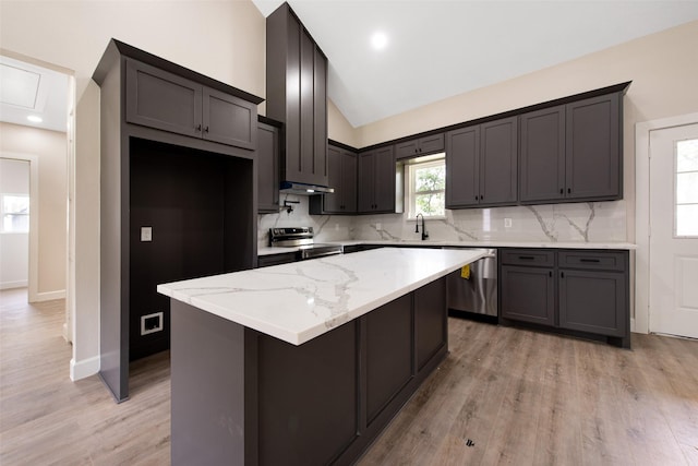 24601 Tipperary St, Hempstead, TX 77445 - kitchen with a kitchen island, stainless steel appliances, decorative backsplash, and lofted ceiling