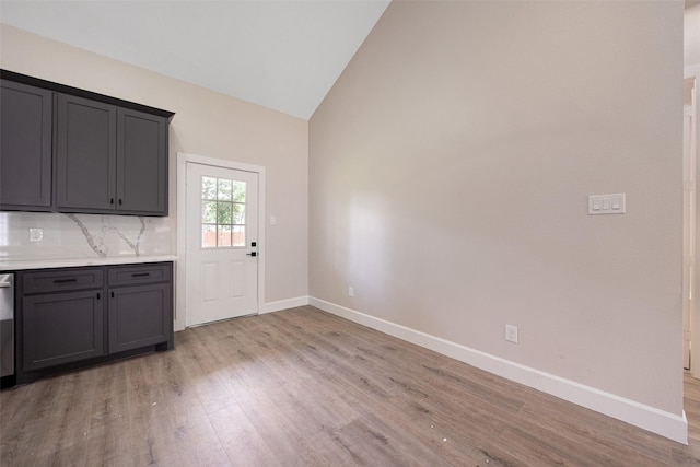24601 Tipperary St, Hempstead, TX 77445 - kitchen with light countertops, gray cabinets, baseboards, decorative backsplash, and light wood-type flooring