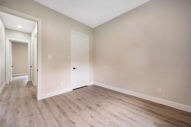 24601 Tipperary St, Hempstead, TX 77445 - unfurnished bedroom with baseboards and light wood-type flooring