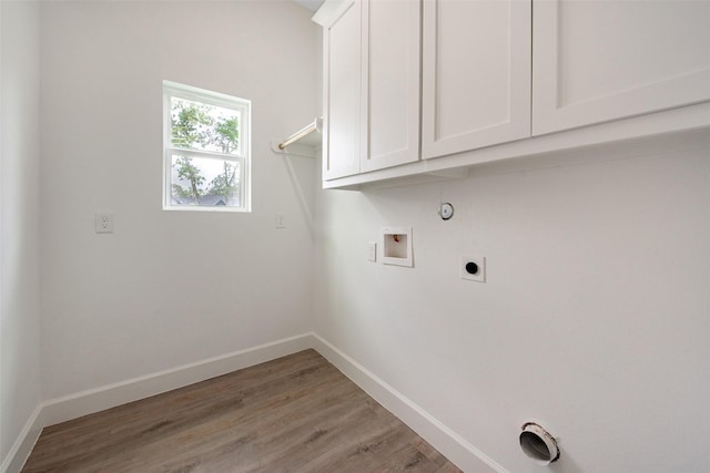 24601 Tipperary St, Hempstead, TX 77445 - clothes washing area with cabinet space, electric dryer hookup, baseboards, and hookup for a washing machine