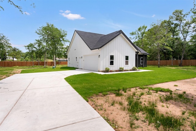 24601 Tipperary St, Hempstead, TX 77445 - view of home's exterior featuring fence, a garage, board and batten siding, concrete driveway, and a lawn
