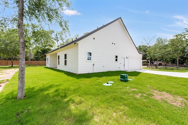 24601 Tipperary St, Hempstead, TX 77445 - view of side of home with a yard, an attached garage, fence, and concrete driveway