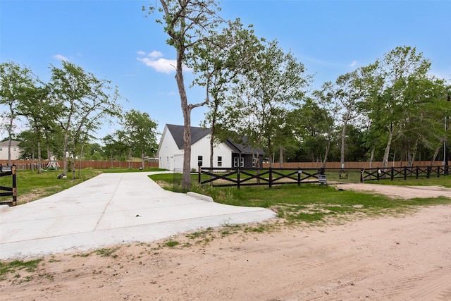 24601 Tipperary St, Hempstead, TX 77445 - view of home's exterior featuring fence, a yard, an attached garage, and concrete driveway