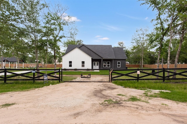 24601 Tipperary St, Hempstead, TX 77445 - view of front of house featuring fence private yard, a gate, a front lawn, and a shingled roof
