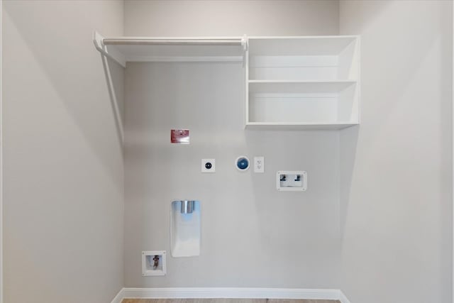 clothes washing area featuring gas dryer hookup, washer hookup, hardwood / wood-style flooring, and hookup for an electric dryer