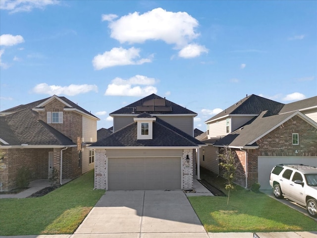 view of front of home with solar panels, a garage, and a front lawn