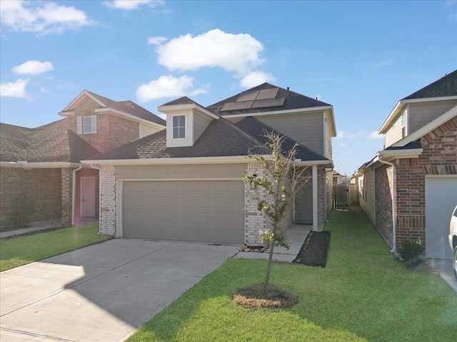 view of front of house with a front yard and a garage