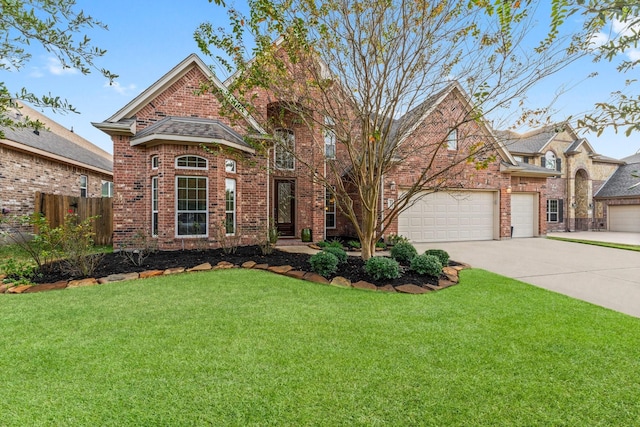 view of front of house featuring brick siding, an attached garage, a front lawn, fence, and driveway