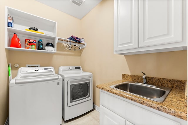 laundry room with visible vents, independent washer and dryer, a sink, cabinet space, and light tile patterned floors