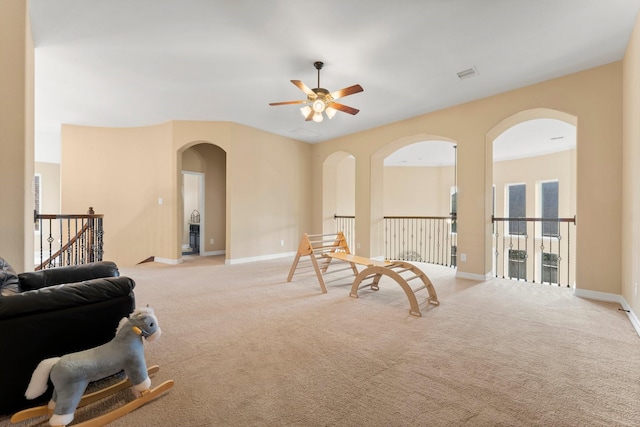 sitting room featuring ceiling fan and light carpet