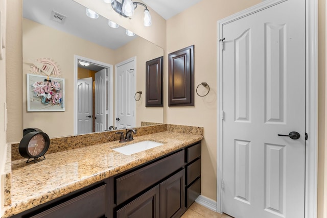 bathroom with tile patterned flooring and vanity