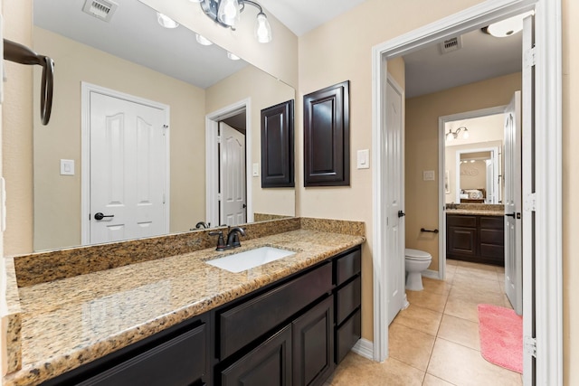 bathroom with tile patterned floors, visible vents, toilet, and vanity