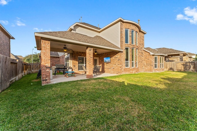 rear view of house with a lawn, ceiling fan, and a patio