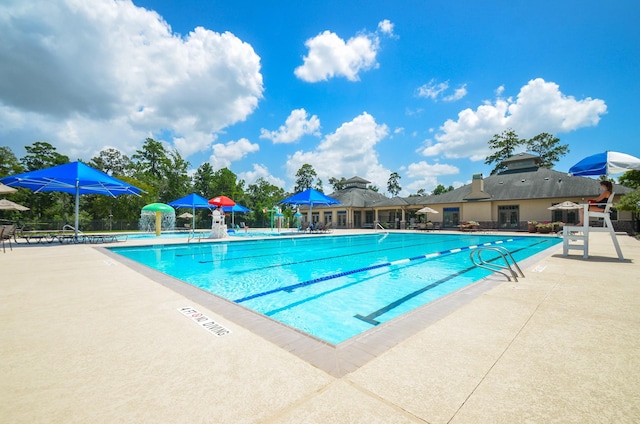 view of pool with pool water feature and a patio