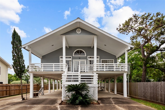 coastal home with a porch and a carport