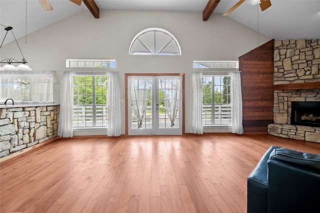 living room with plenty of natural light, hardwood / wood-style floors, a fireplace, and ceiling fan