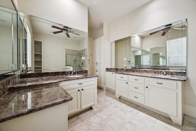 bathroom featuring tile patterned floors, vanity, and a shower with shower door