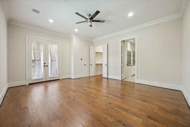 empty room featuring french doors, hardwood / wood-style flooring, ceiling fan, and crown molding