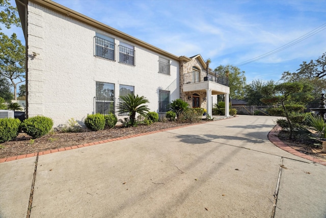 view of side of home featuring a balcony