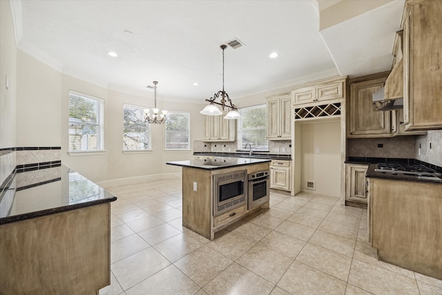 kitchen featuring a kitchen island, light tile patterned floors, backsplash, and appliances with stainless steel finishes