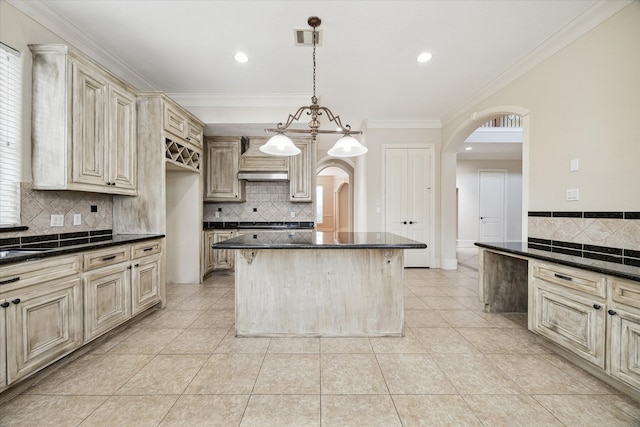 kitchen with ornamental molding, hanging light fixtures, light tile patterned floors, and custom range hood