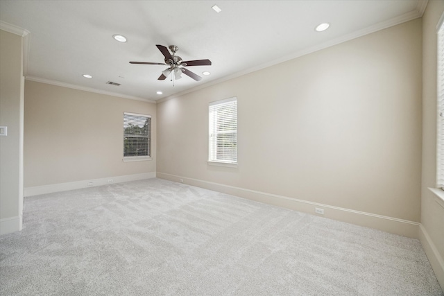 carpeted empty room with ceiling fan and crown molding