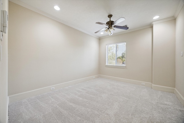 empty room featuring crown molding, carpet floors, and ceiling fan