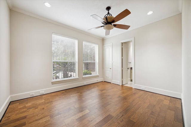 spare room with crown molding, hardwood / wood-style floors, and ceiling fan